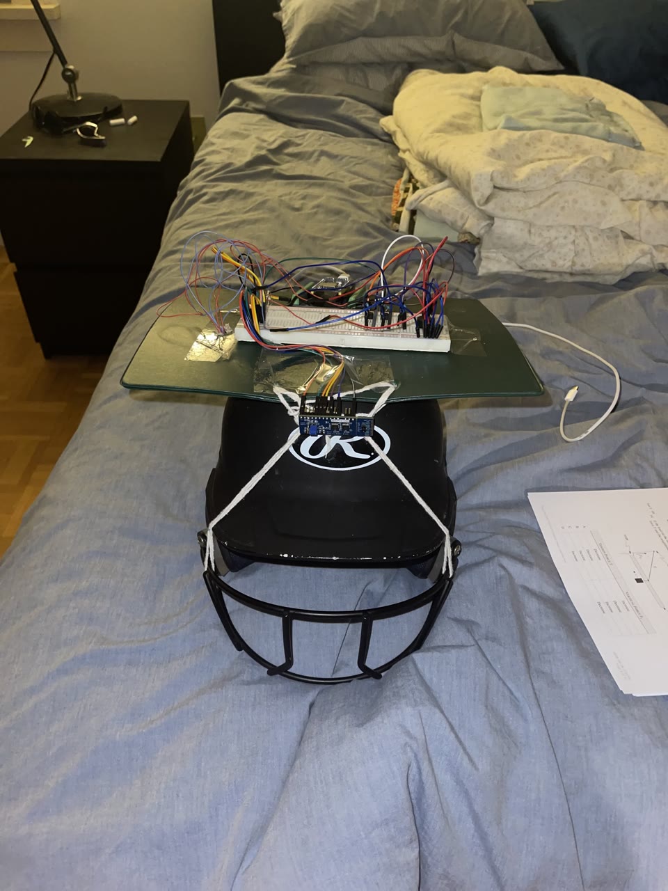 First helmet rig: breadboard and sensors mounted on a batting helmet